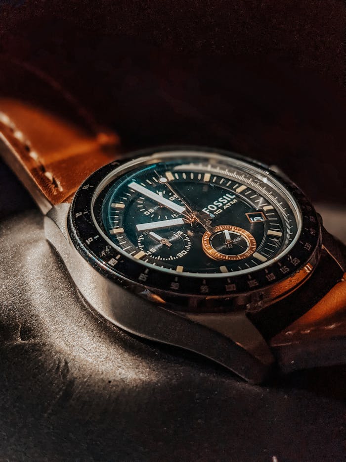 Detailed view of a luxury wristwatch with a leather strap highlighting intricate watch face features.